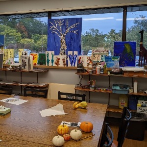 Art room with table filled with art projects