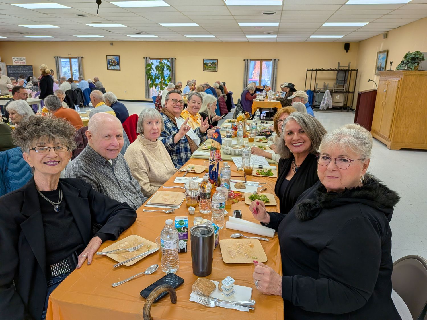 Several older people gathered for a Thanksgiving meal at a community center