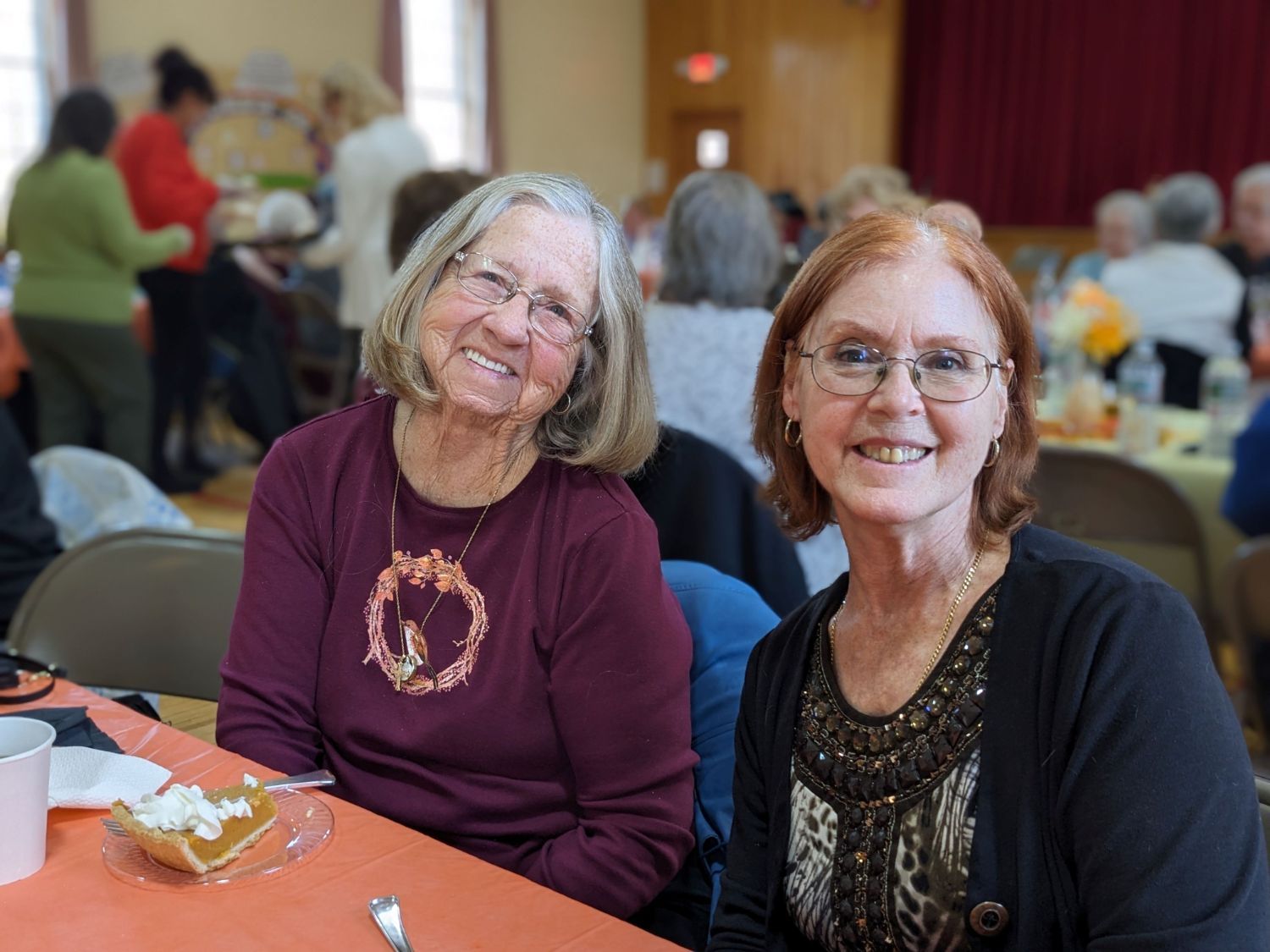 Two women smiling at Thanksgiving meal