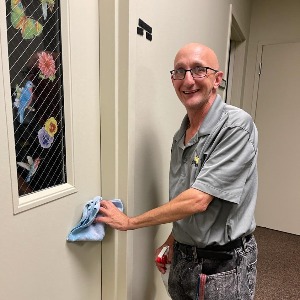 man cleaning door handle